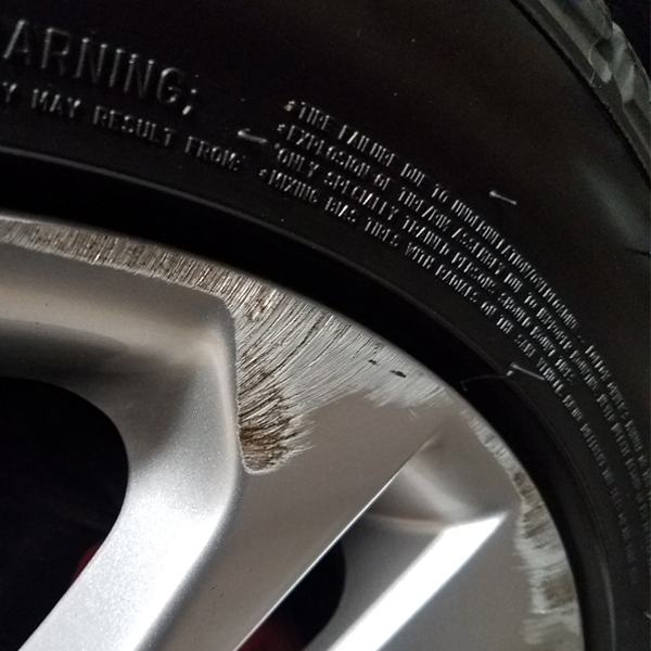Alloy wheel with a curb rash damage