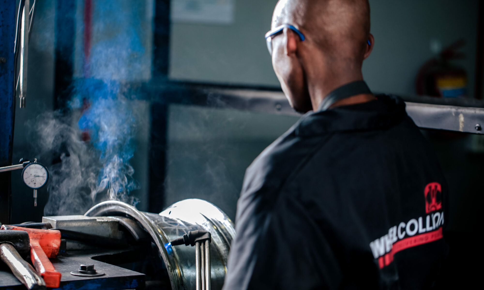 Wheel Repair Specialist using a welding machine to repair an alloy wheel