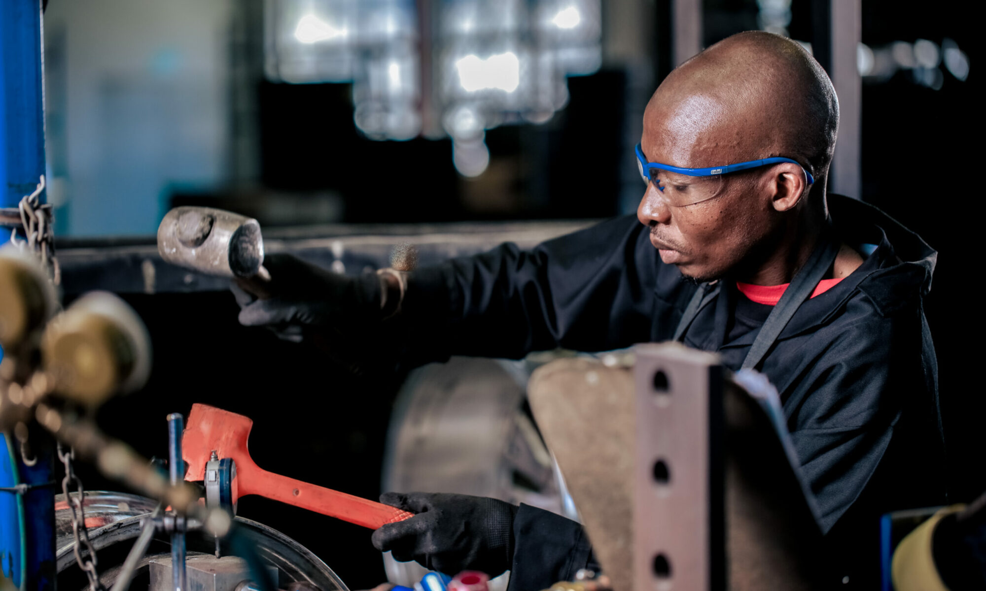 Man straightening a car wheel